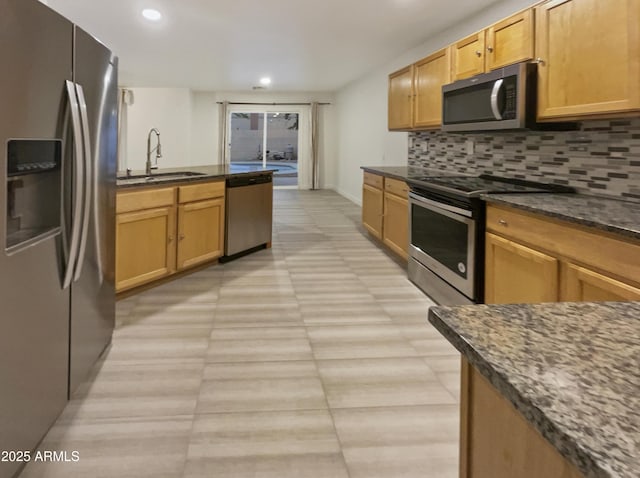 13033 W Avalon Dr, Avondale, AZ 85392 - kitchen with tasteful backsplash, dark stone countertops, sink, and appliances with stainless steel finishes