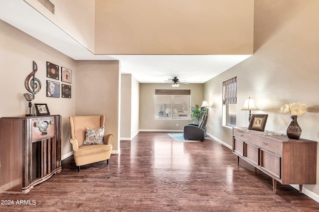 sitting room featuring ceiling fan and dark wood-type flooring