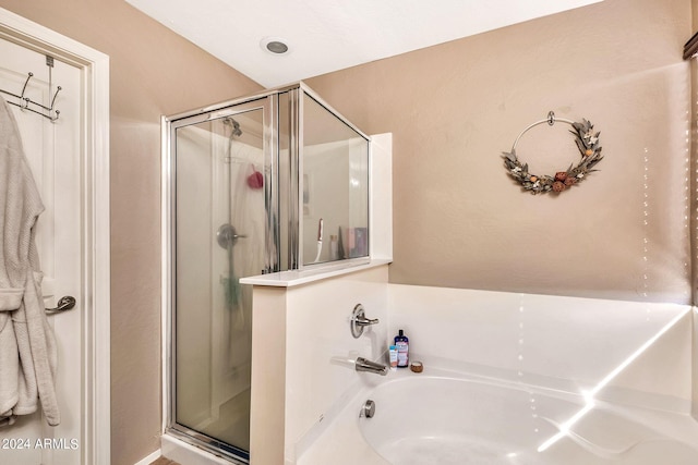 bathroom with separate shower and tub