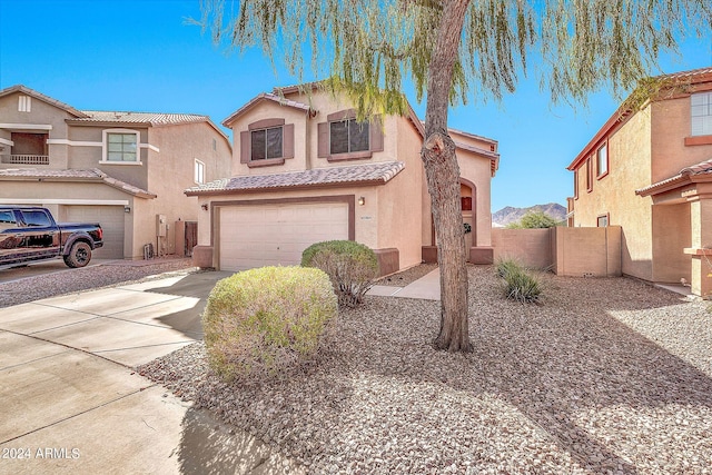 view of front of property featuring a garage and a mountain view