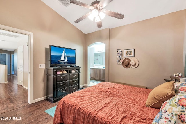 bedroom with ceiling fan, connected bathroom, lofted ceiling, and dark hardwood / wood-style floors