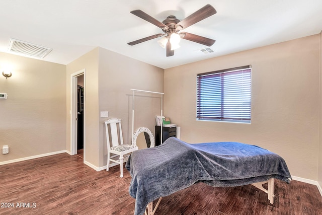 bedroom with dark hardwood / wood-style flooring and ceiling fan