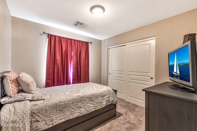 carpeted bedroom with a closet