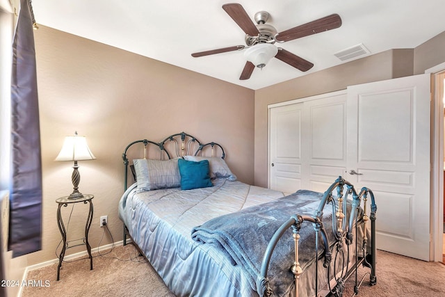 bedroom with carpet flooring, ceiling fan, and a closet