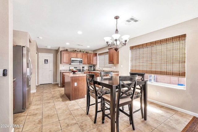 tiled dining space featuring a notable chandelier