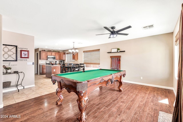 playroom with ceiling fan with notable chandelier, light wood-type flooring, and pool table