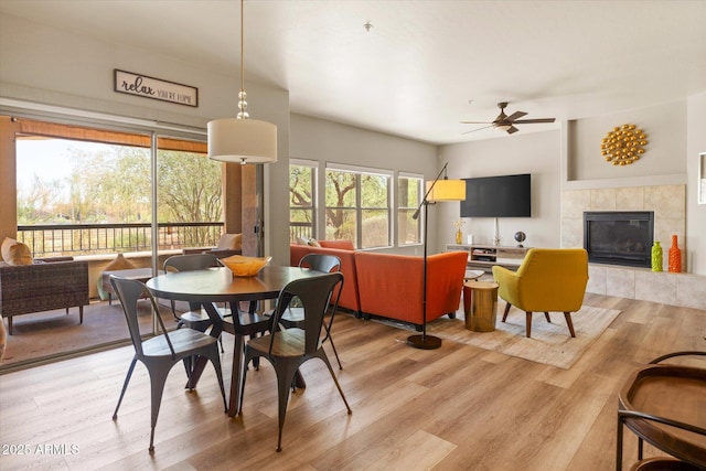 19700 N 76th St Unit 1038, Scottsdale, AZ 85255 - dining space with ceiling fan, light wood-type flooring, and a tiled fireplace