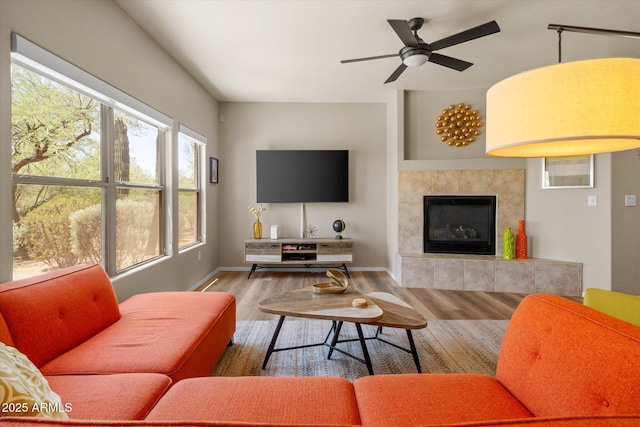 19700 N 76th St Unit 1038, Scottsdale, AZ 85255 - living room with wood finished floors, a ceiling fan, and a fireplace