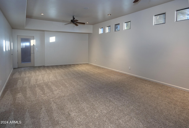 basement with carpet and ceiling fan