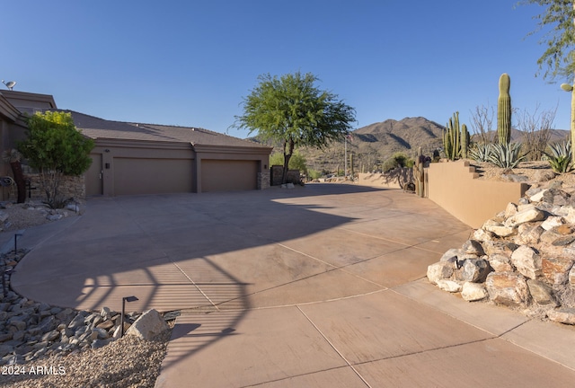 exterior space featuring a garage and a mountain view