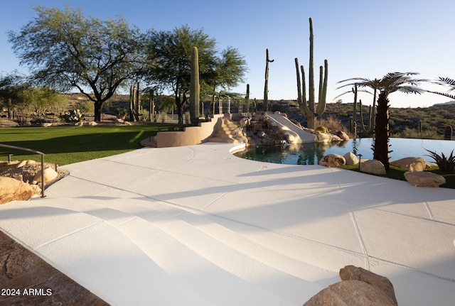 view of community with a patio area and a swimming pool