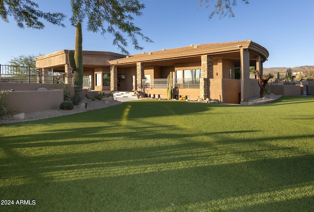 rear view of house featuring a yard and a patio