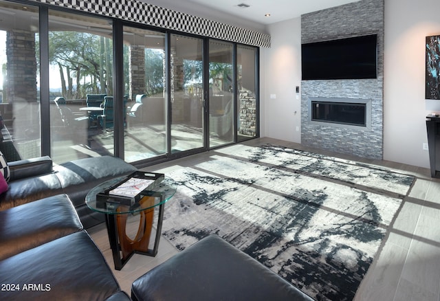 living room with wood-type flooring and a fireplace