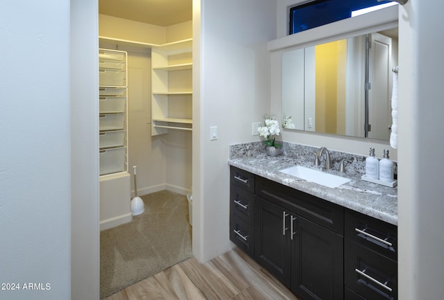 bathroom featuring vanity and hardwood / wood-style flooring