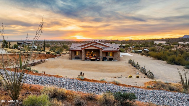 view of back house at dusk