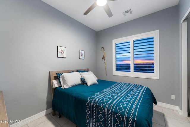 bedroom with ceiling fan and light tile patterned floors