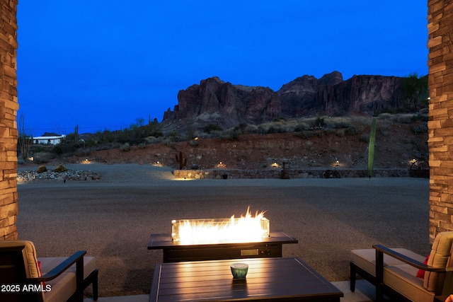 exterior space featuring a mountain view and an outdoor fire pit