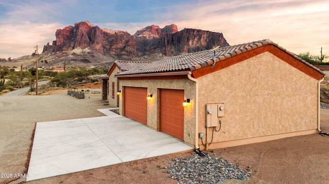 exterior space with a mountain view and a garage