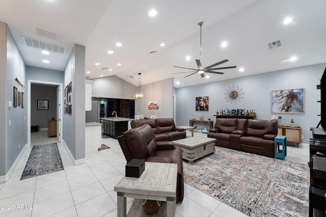 living room with ceiling fan, vaulted ceiling, and light tile patterned floors