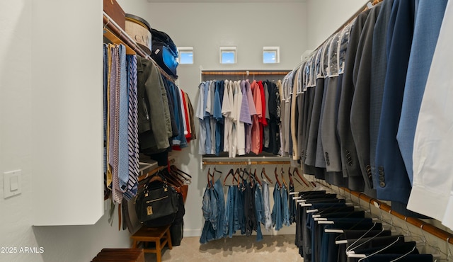 walk in closet featuring carpet flooring