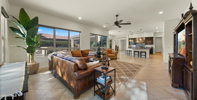 tiled living room with ceiling fan