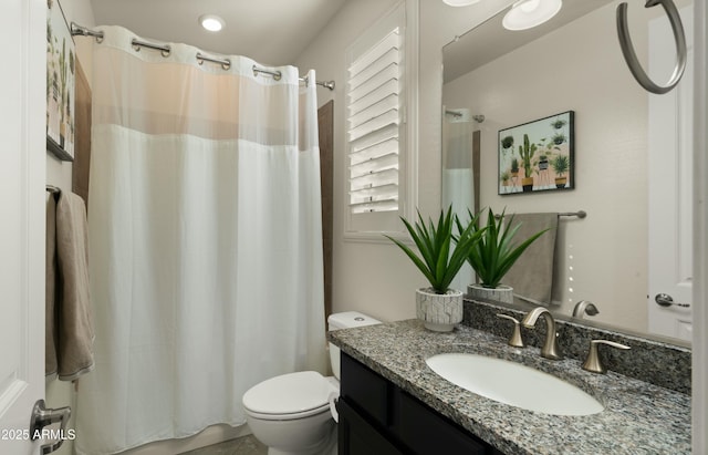 bathroom featuring toilet, vanity, and a shower with shower curtain