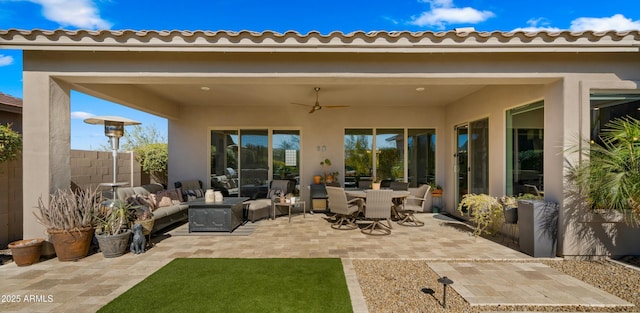 view of patio / terrace with ceiling fan and an outdoor living space