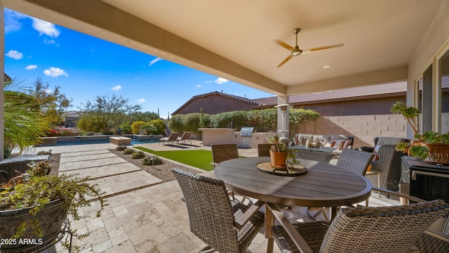 view of patio / terrace with ceiling fan and an outdoor kitchen