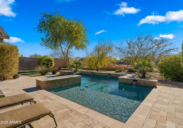 view of swimming pool featuring pool water feature, a hot tub, and a patio area