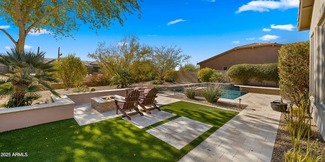 view of yard with a fire pit and a patio