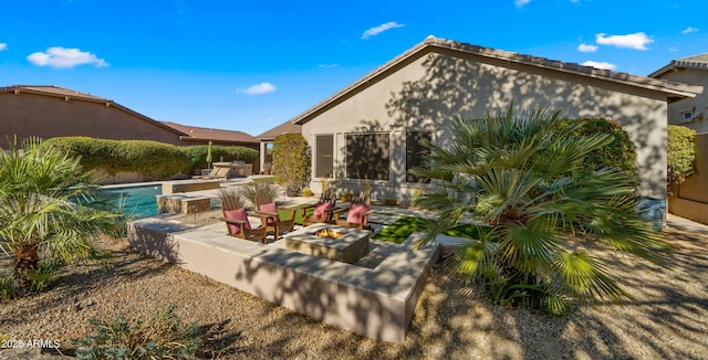 view of patio / terrace featuring an outdoor kitchen and a fire pit