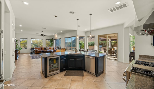 kitchen featuring ceiling fan, wine cooler, light tile patterned floors, and stainless steel appliances