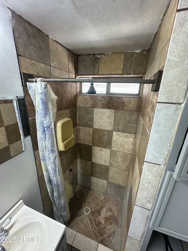 bathroom featuring vanity, a shower with curtain, and a textured ceiling