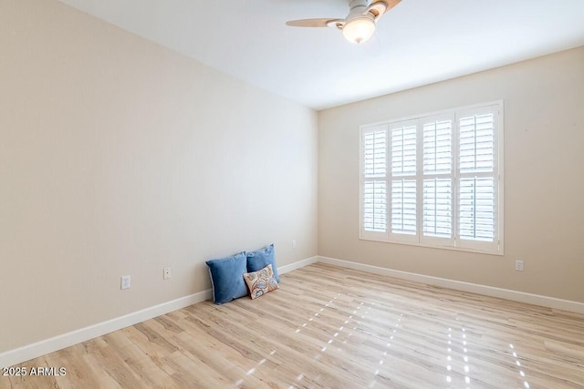 empty room featuring ceiling fan and light hardwood / wood-style flooring