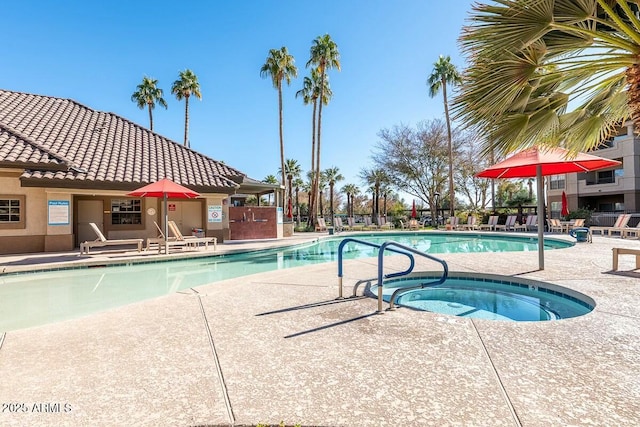 view of swimming pool featuring a patio area and a community hot tub