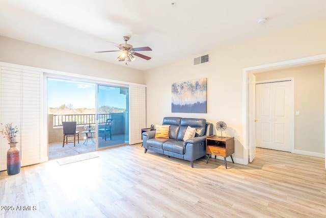 living room with ceiling fan and light wood-type flooring