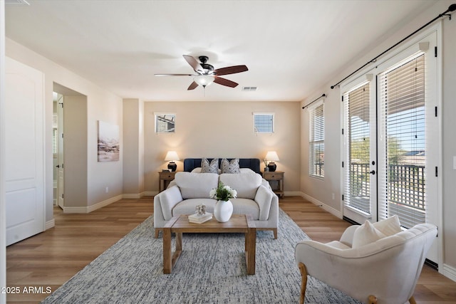 bedroom with access to exterior, visible vents, light wood-type flooring, and baseboards