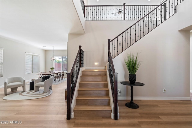 stairway featuring wood finished floors and baseboards