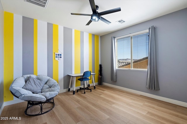 sitting room featuring visible vents, baseboards, and wood finished floors