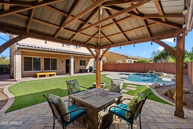 view of patio / terrace featuring a gazebo, outdoor dining space, a fenced in pool, and a fenced backyard