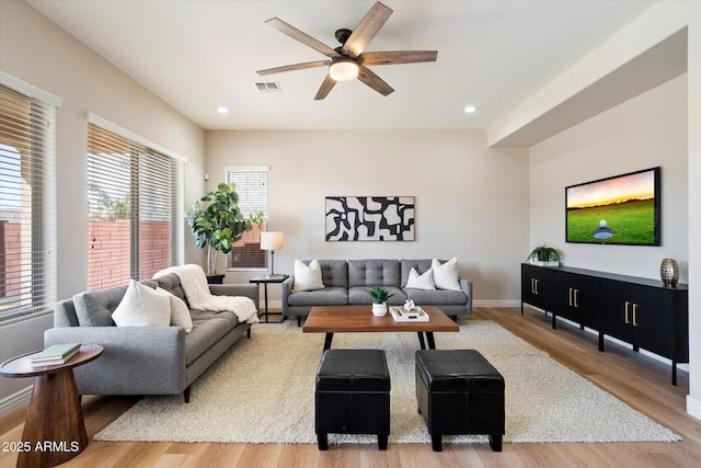 living area featuring visible vents, recessed lighting, light wood-style floors, baseboards, and ceiling fan