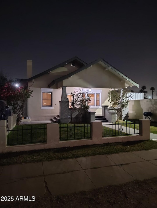126 N 9th Ave, Phoenix, AZ 85007 - view of front of house featuring stucco siding and a fenced front yard