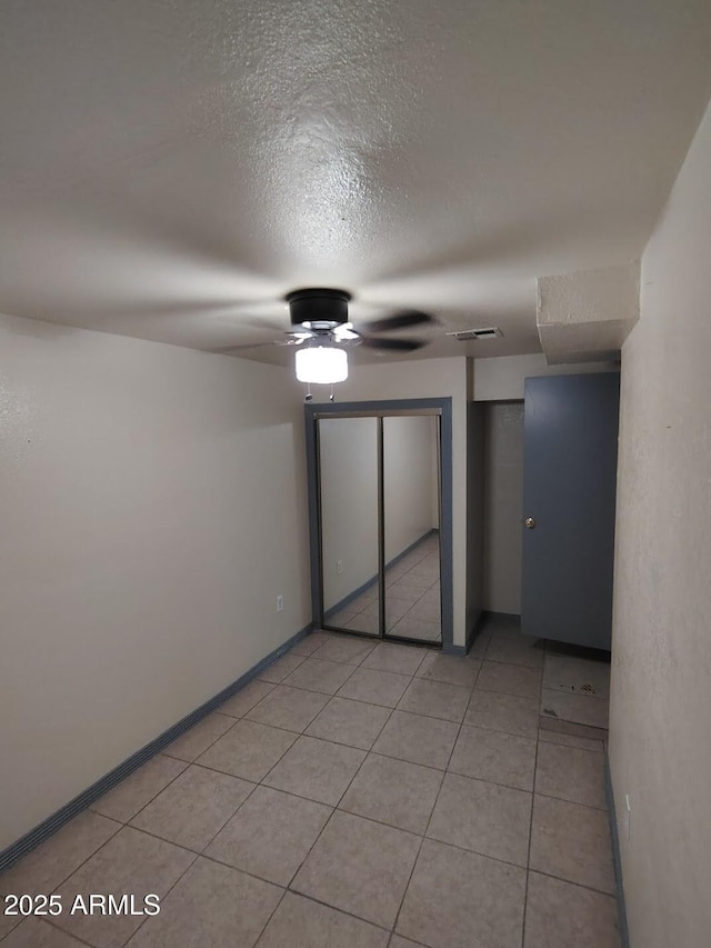 126 N 9th Ave, Phoenix, AZ 85007 - unfurnished bedroom with multiple closets, light tile patterned floors, a ceiling fan, and a textured ceiling