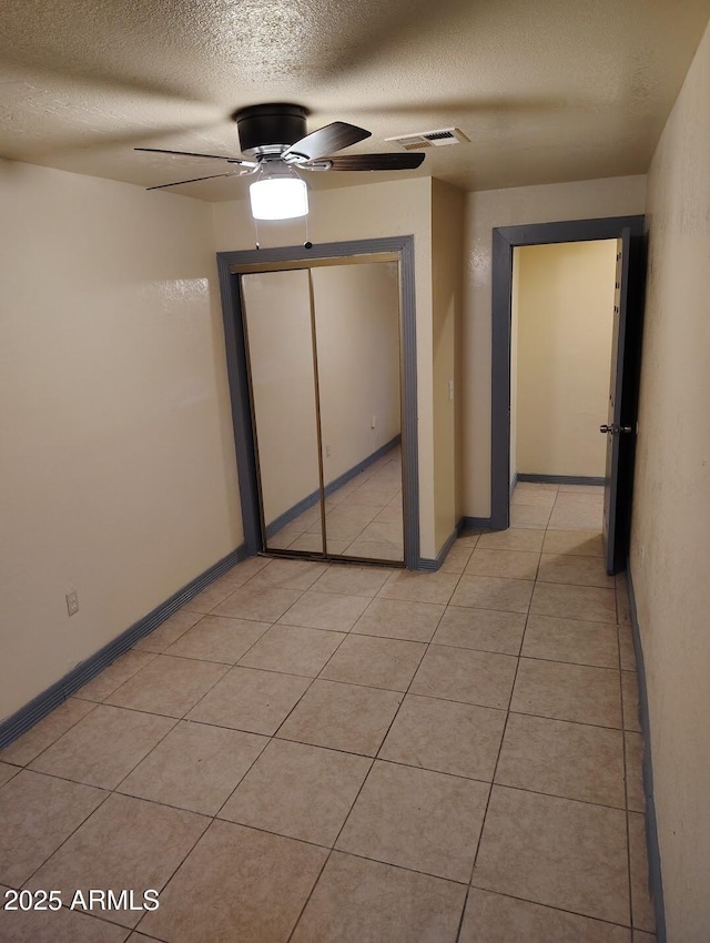126 N 9th Ave, Phoenix, AZ 85007 - unfurnished bedroom with a textured ceiling, a closet, ceiling fan, and light tile patterned flooring