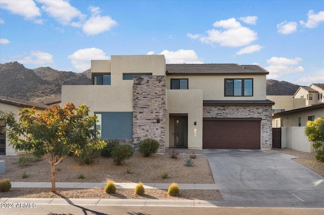 view of front of property with a mountain view and a garage