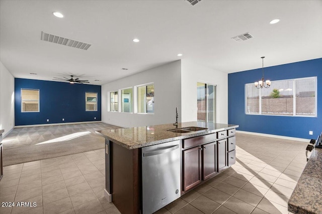 kitchen featuring light stone countertops, dishwasher, sink, pendant lighting, and ceiling fan with notable chandelier