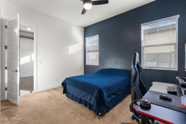 bedroom featuring light colored carpet and ceiling fan