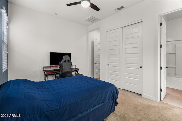 bedroom with ensuite bath, ceiling fan, a closet, and carpet