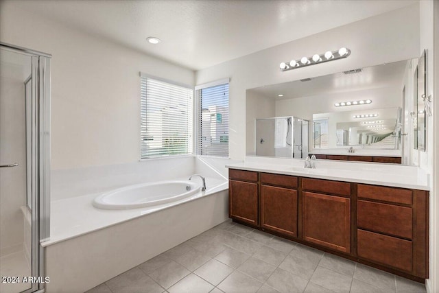 bathroom with tile patterned floors, vanity, and plus walk in shower