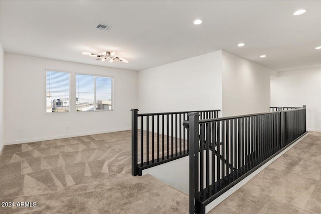 corridor with light colored carpet